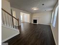Open-concept living room with dark hardwood floors, fireplace, and ample natural light at 5425 Twin Lakes Dr, Atlanta, GA 30349