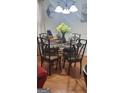 Cozy dining room features a glass table, seating for six, and warm wood floors at 1923 Manhattan Pkwy, Decatur, GA 30035