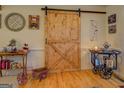 Interior view featuring a rustic sliding barn door adding character to the home at 25 Old Blue Pt, Social Circle, GA 30025