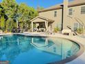 Backyard swimming pool with an inviting patio area, complete with comfortable seating and outdoor dining options at 39 Hannah Way, Palmetto, GA 30268