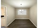Cozy dining area featuring modern vinyl flooring and a contemporary chandelier for a warm ambiance at 2296 Aurie Dr, Decatur, GA 30034