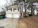 Charming two-story home with a brick facade, attached garage, and mature landscaping at 2296 Aurie Dr, Decatur, GA 30034