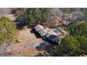 Sprawling property featuring brick home with a large pool and a spacious backyard surrounded by mature trees at 160 Appalachee Church Rd, Auburn, GA 30011