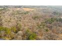 Expansive aerial view of lush, wooded property awaiting development at 116 Appalachee Church Rd, Auburn, GA 30011