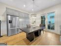 Open-concept kitchen featuring stainless steel appliances and custom cabinetry at 130 Glasgow Ln, Fayetteville, GA 30214