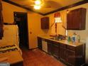 Functional kitchen featuring wooden cabinetry, a double-basin sink, and basic appliances at 7755 Chase Woods Dr, Jonesboro, GA 30236