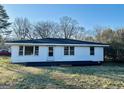 Back exterior of home featuring white siding, black painted foundation, and black trim at 225 Bell St, Covington, GA 30016