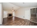 Spacious living room with a stone fireplace, ceiling fan, and staircase at 3417 Little Beth Ct, Decatur, GA 30034