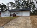 Single-story home with a gray painted brick exterior and driveway at 3339 Clevemont Ct, Ellenwood, GA 30294