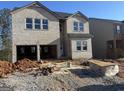 New construction two-story brick home with an open garage, surrounded by a gravel lot at 5343 Tolar Rd # 58, South Fulton, GA 30213