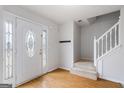 Foyer with decorative glass door, wood flooring, and staircase leading to the upper level at 825 Karie Dr, Mcdonough, GA 30253