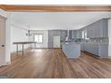 Open concept kitchen with gray cabinets, granite countertops, and modern appliances at 6274 Booker Ln, Lithonia, GA 30058