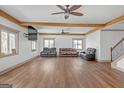 Spacious living room featuring hardwood floors, a ceiling fan, and comfortable seating at 6274 Booker Ln, Lithonia, GA 30058