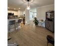Open floor plan with bar seating adjacent to the kitchen, with hardwood floors and natural light at 7050 Galloway Pt, Riverdale, GA 30296