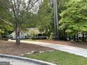 Long driveway leading to the home, surrounded by mature trees and landscaping at 200 Timber Ridge Dr, Mcdonough, GA 30252