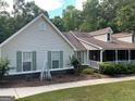 Inviting single-Gathering home with green shutters, vinyl siding, brick accents, and a lovely front porch at 200 Timber Ridge Dr, Mcdonough, GA 30252