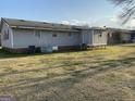 Exterior view of home with a backyard featuring a spacious lawn at 376 Lakewood Dr, Social Circle, GA 30025