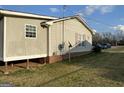 Side view of home with siding and brick foundation at 376 Lakewood Dr, Social Circle, GA 30025