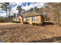Cozy brick home with mature landscaping and shuttered windows at 195 Youngs Cir, Fayetteville, GA 30215