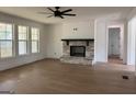 Bright living room features a stone fireplace, hardwood floors, and large windows at 130 Dockside Dr # 380, Fayetteville, GA 30215