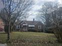 Charming brick home with a well-maintained front yard and mature trees, offering curb appeal and a touch of nature at 1948 Shirley Sw St, Atlanta, GA 30311