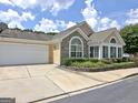 Well-maintained home featuring a two-car garage, stone accents, and neatly trimmed landscaping at 430 Rehobeth Way, Fayetteville, GA 30214