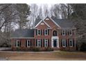 Attractive brick home with a manicured front yard and traditional architectural details at 155 Glenwood Ln, Fayetteville, GA 30215