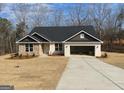 Well-manicured lawn enhances the appeal of this single-story home with a two-car garage and black shingle roof at 3382 Milan Ct # 3 Plapprox Sqft 3, Douglasville, GA 30135