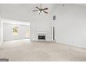 Spacious, open-concept living room with a fireplace, neutral tones, and ample natural light at 153 Cedar Ridge Rd, Locust Grove, GA 30248