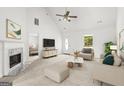 Bright living room with vaulted ceiling, fireplace, stylish furnishings and a large sunlit window at 153 Cedar Ridge Rd, Locust Grove, GA 30248