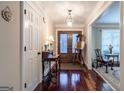 A home entryway featuring a hardwood floor and double wood doors at 3030 Shallowford Park Mnr, Roswell, GA 30075