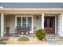 Close up of a tiled front porch area with bench and double-door entry at 3030 Shallowford Park Mnr, Roswell, GA 30075