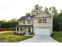 Two-story home with gray siding, a covered front porch, a two-car garage, and a well-manicured lawn at 1825 Harmony Trce # 6, Lithonia, GA 30058