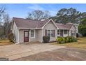 Charming single-story home with neutral siding, red shutters, a brown roof, and a long driveway at 3645 Fay Dr, Rex, GA 30273