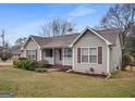 Charming single-story home with neutral siding, red shutters, a brown roof, and a cozy front porch at 3645 Fay Dr, Rex, GA 30273