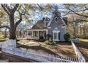 Charming two-story home featuring unique architecture and a inviting front porch at 86 Victoria Dr, Moreland, GA 30259