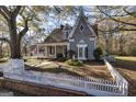 Charming two-story home featuring unique architecture and a inviting front porch at 86 Victoria Dr, Moreland, GA 30259