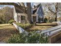 Charming two-story home featuring unique architecture with a big tree in the front yard at 86 Victoria Dr, Moreland, GA 30259