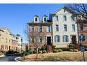 Attractive townhome showcasing brick facade, dormer windows, and well-maintained landscaping at 6422 Paulson, Atlanta, GA 30328