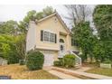 Two-story home with an inviting front porch, attached garage, black shutters, and tasteful landscaping at 5827 Highgrove Dr, Atlanta, GA 30349