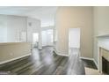 Open-concept living room featuring vinyl flooring, a fireplace, and smooth, neutral-colored walls at 5827 Highgrove Dr, Atlanta, GA 30349