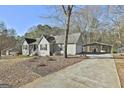 Charming home with a covered parking area and mature trees at 100 Rockland Trl, Sharpsburg, GA 30277