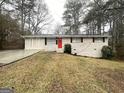 Cozy single-story home featuring a bright red front door and a well-maintained lawn at 4954 Springbrook Dr, Douglasville, GA 30135