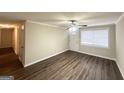 Inviting living room with laminate floors, ceiling fan, and an entry door with a window at 4954 Springbrook Dr, Douglasville, GA 30135