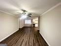 Spacious living room featuring hardwood floors and an open layout that flows into the kitchen at 4954 Springbrook Dr, Douglasville, GA 30135