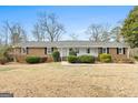 Classic brick home with a symmetrical facade, showcasing a well-maintained lawn and inviting covered entry at 3411 Airline Rd, Mcdonough, GA 30252