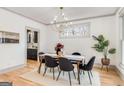 Bright dining room featuring wood floors, modern lighting, and views of the kitchen at 1055 Ormewood Se Ave, Atlanta, GA 30316