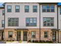 Attractive townhome showcasing a mix of brick and siding, enhanced by multiple windows for natural light at 2624 Caruso Way, Atlanta, GA 30339