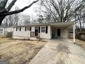 Exterior view of a single-story home with a covered parking area and front porch at 2060 Sanders Dr, Austell, GA 30168