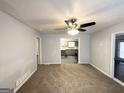 Inviting living room with carpet floors and a view into the kitchen at 29 Hickory Ct, Dallas, GA 30157